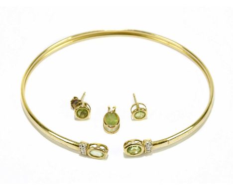 A yellow metal peridot set bangle with matching earrings and pendant, combined approx. 6.1g.Condition Report: The bracelet is