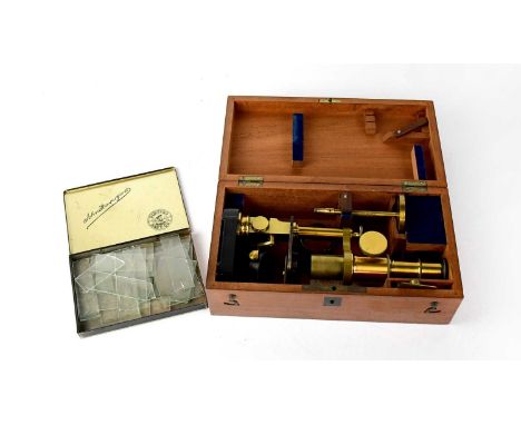 A. FRANKS OPTICIAN, MANCHESTER; A cased brass monocular microscope with additional tin of unused glass slides (2).