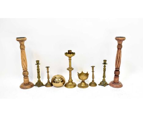 A 19th century ecclesiastical brass candlestick with knopped stem and domed foot, together with two other pairs of brass cand
