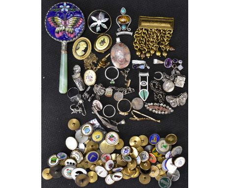 Various items of costume jewellery to include brooches, rings, pendants, silver charms, a modern Chinese jade-style hand mirr