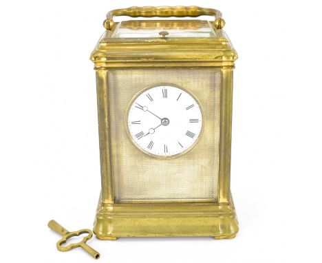 A late 19th century brass chiming carriage clock with glazed panels top front and sides, the white enamelled dial set with Ro