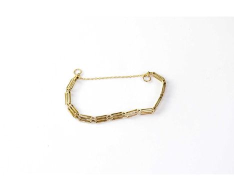 A 9ct gold three bar gate bracelet with safety chain, stamped 375, approx. 9.1g.