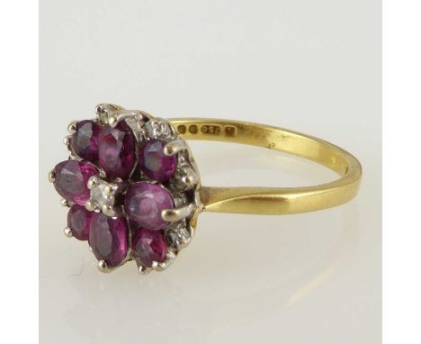 An 18ct gold ruby and diamond flower head cluster ring, size P, approx. 4g.