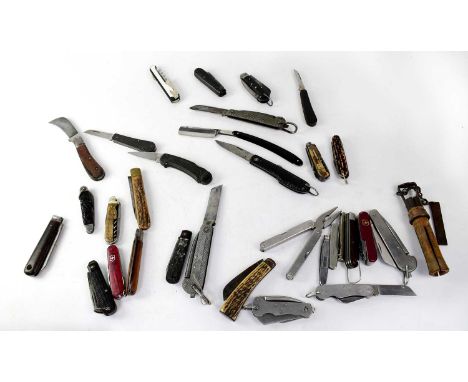 A quantity of vintage and contemporary penknives to include Swiss Army examples.