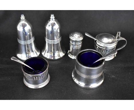 An Elizabeth II hallmarked silver three-piece cruet comprising pepperette, salt and mustard, with blue glass liners, and a ha