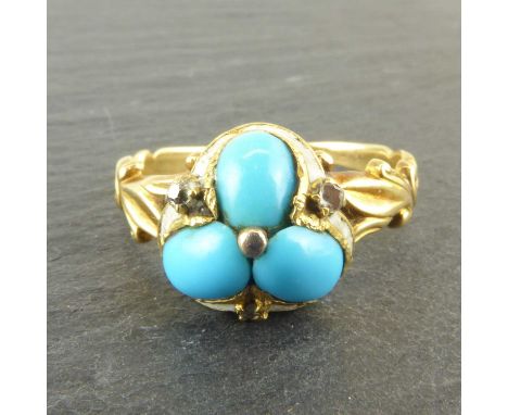 A yellow metal Art Deco inspired ring with three turquoise beads separated with three tiny claw set diamonds in a border of w