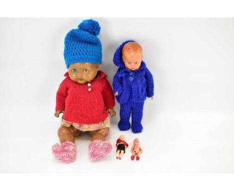 Four vintage celluloid dolls to include one brown example with blue eyes and dressed in woollens, length 39cm, one with rosy 