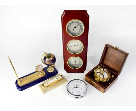 A wall-mounted three-dial set comprising a clock, hygrometer and thermometer, in a mahogany case, battery-powered, a chrome c