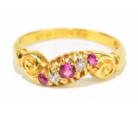 An Edwardian 18ct yellow gold diamond and ruby set dress ring, size M1/2, approx. 3.4g.