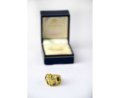 An 18ct yellow gold ring of abstract coral form, set with oval opals, size K, approx. 7.4g.