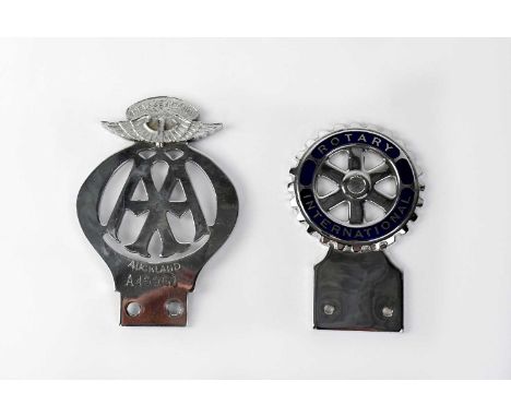 An AA car badge for New Zealand, impressed 'Auckland A45961', and a white metal and blue enamelled 'Rotary International' car