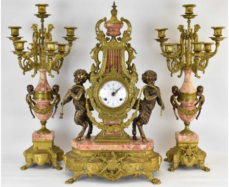 IMPERIAL; an early/mid-20th century clock garniture, the gilt metal lyre body of the clock with two opposing fawns holding a 