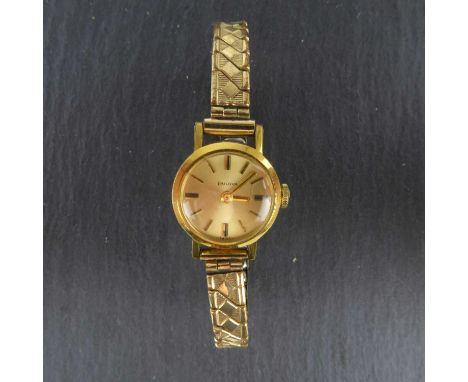 BULOVA; a ladies' vintage gold plated wristwatch, the gold-coloured dial set with raised baton numerals, crown wound movement