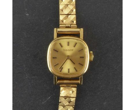 TISSOT; a ladies' 9ct gold crown wind wristwatch, the cushion-shaped gold-coloured dial set with baton numerals, in a 9ct gol