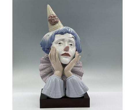 Glossy finish porcelain bust of a sad clown with a cone hat. Lladro backstamp. This item has a base included: 5.25"L x 6.5"W 