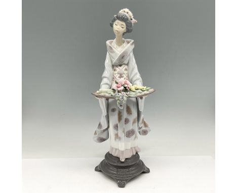 Lovely, retired piece is designed with soft colors and intricate details throughout. Lladro backstamp. This item has its orig