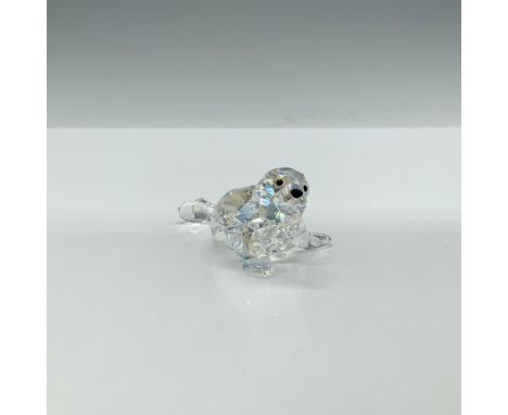 A clear faceted figure of a seal pup with a shimmering iridescent sheen, featuring black eyes and nose. 2012 SCS Exclusive. A