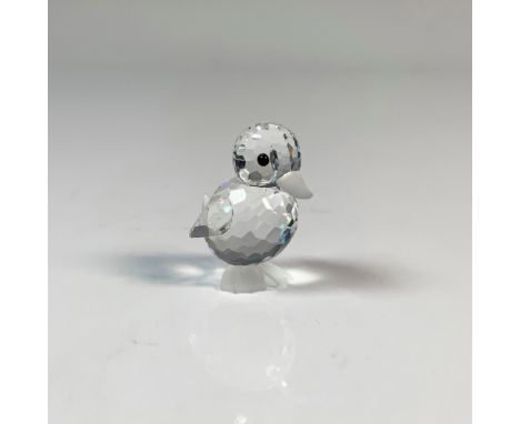 A standing duckling looking forward. It has a clear cut crystal body, frosted bill and feet and black eyes. This item has its