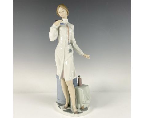 A glossy sculpture of a doctor wearing a white coat dress, looking closely at a thermometer. Lladro backstamp. Artist: Salvad
