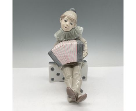 Glossy figure, Pierrot seated on a large domino tile, playing the accordion. Lladro backstamp. Artist: Juan HuertaIssued: c. 