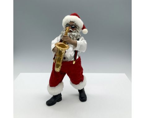 A whimsical Holiday figurine featuring Santa Claus wearing sunglasses and putting on a performance as he plays the saxophone 