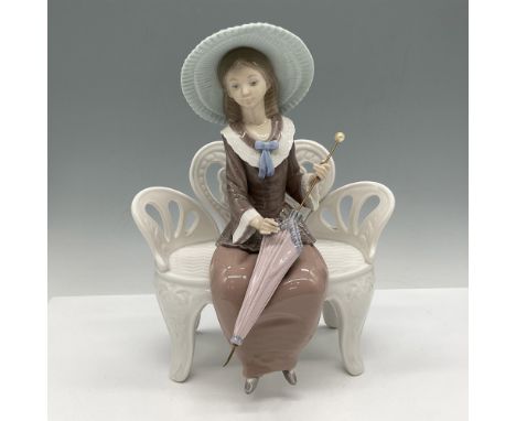 Glossy figure in vintage attire seated on a white bench, umbrella in hand. Lladro backstamp. Artist: Francisco CatalaIssued: 