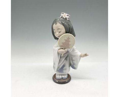 Glossy figure in traditional dress holding fan. Colored in white, lavender, pink and pale green. Lladro backstamp. This item 