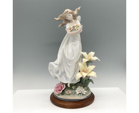 Glossy limited-edition figure is 1187 of 5000. Young woman is holding flowers, standing in a garden of flowers. Lladro backst