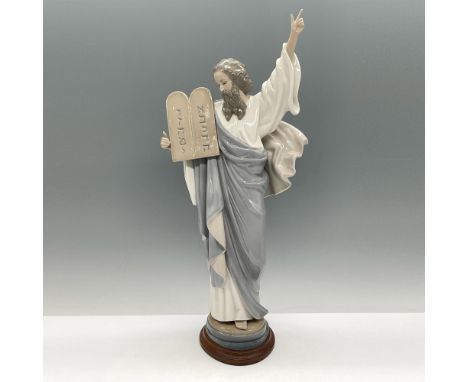 Beautiful, glossy figure holding tablets. Colored in soft grey, blue and brown. Lladro backstamp. This item has a base includ