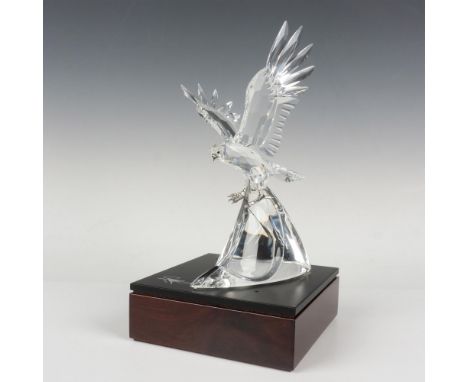 Majestic clear crystal with metal beak and claws. Includes: A wooden signed base, gloves, a polishing cloth, a hardcover piec