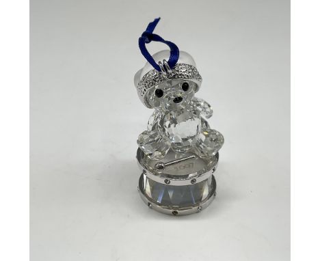 Part of the Kris Bear group, this annual edition is sitting atop crystal drum and wearing a satin crystal hat. This item has 