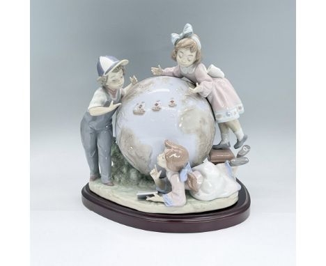 Glossy porcelain figural of three children looking at a globe and the aquatic voyage of Columbus. Lladro backstamp. Limited E