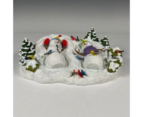 A delightful Holiday tableau figurine of two snowmen making snow angels. The detail to the wintery scene is excellent, to the