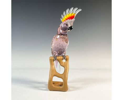 A faceted Kakadu red crystal figure depicting a bird with a frosted orange-red crest of feathers, silver-tone feet and beak, 