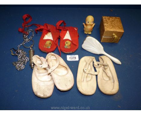 A small quantity of vintage baby's shoes, first hairbrush and toy duck (a/f) and a ''Metropolitan'' Whistle on chain, etc.