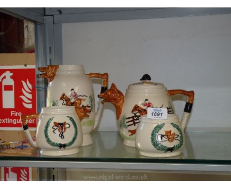 A four piece Hunting Teaset comprising teapot, large and small Jug and sugar bowl, each with with fox head to spout and whip 