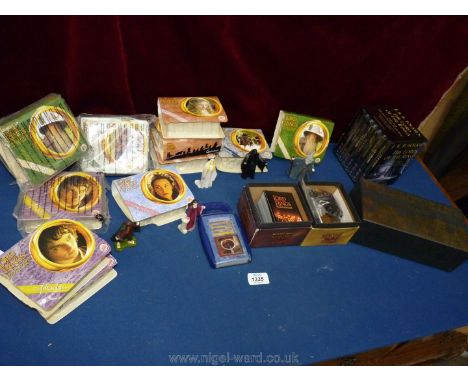 A box of figures and trading cards from Lord of The Rings together with two audio cassettes of The Fellowship of The Ring.