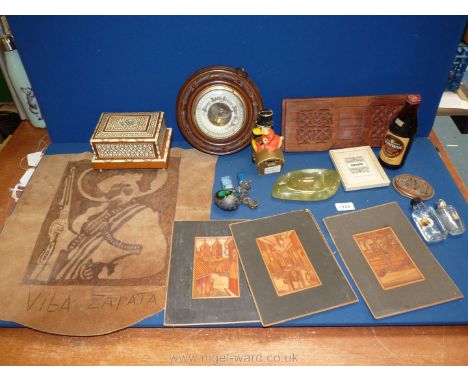 A box of miscellanea including four straw/reeded pictures, book slide, round barometer, mother of pearl inlaid cigarette box,