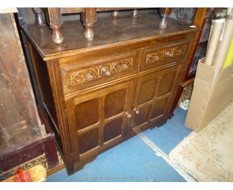 A compact Old Charm/Priory style dark Oak Sideboard of compact size having two frieze drawers and a pair of opposing four pan
