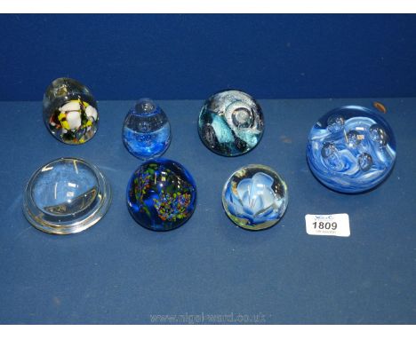 Seven paperweights including millefleur type, abstract, blue swirl etc., some chips