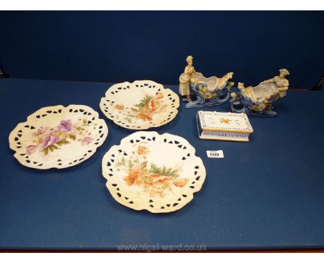 Three china ribbon plates, a small china book  'Joys Many, Sorrows Few', decanter with cork stopper, two cherub posy vases et
