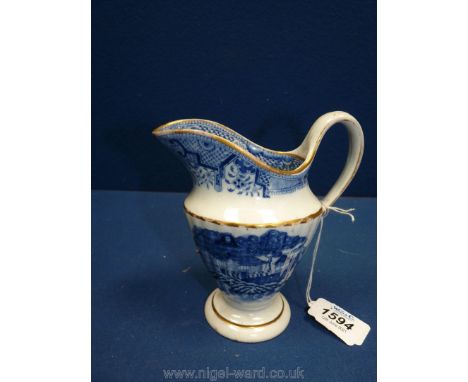 A rare New Hall pedestal cream jug circa 1795, printed in blue and white with the factory's version of the bridge and willow 