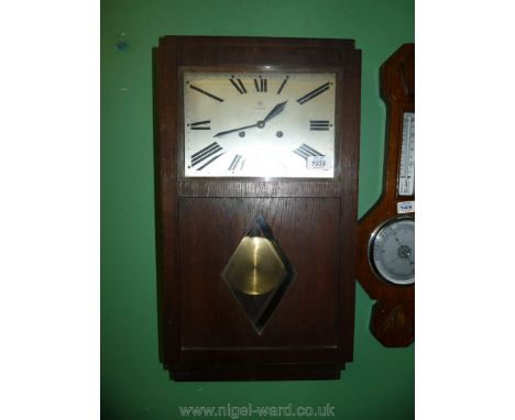 An Oak cased art deco design Wall Clock by Junghans having a rectangular face with Roman numerals and chiming two strain spri