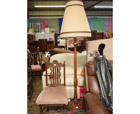 A polished turned Mahogany Standard Lamp having a lined beige pleated shade.