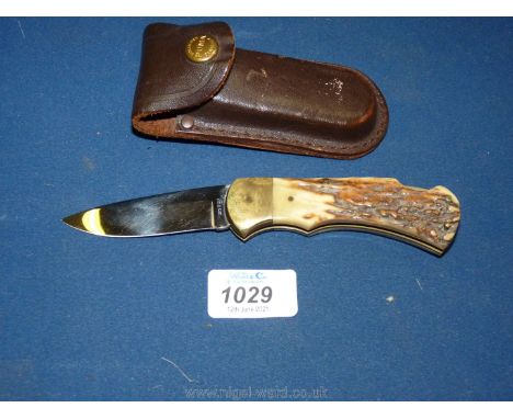 A vintage 'Puma' hunting Knife with stag horn handle in it's original leather sheath and the blade stamped 'Rostieri'. The ca