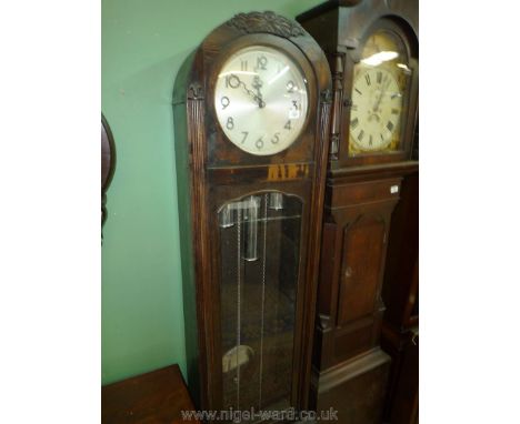 A 20th c. arched top Oak cased Longcase Clock having a silvered dial with Arabic numerals, the three train movement with chro