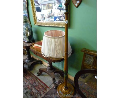 A turned Maple type wood Standard Lamp having applied floral decoration and with a pleated and tasselled pink shade.