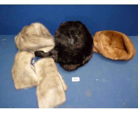 Three fur hats:  one grey with scarf, one brown and black Trapper hat.