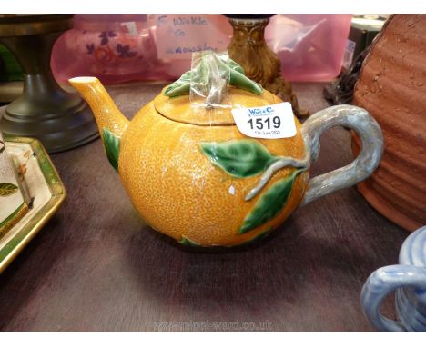 A decorative vintage Portuguese teapot in the form of an orange, with stem handle and relief stems and leaves, tine chip to s