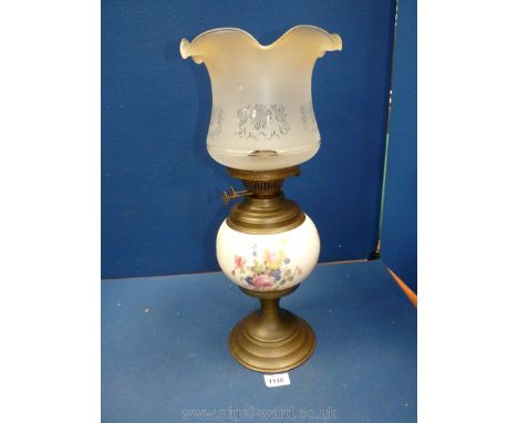 A brass and ceramic Oil Lamp with floral decoration to the cental bowl, frosted glass shade and twin burner, 19" tall.